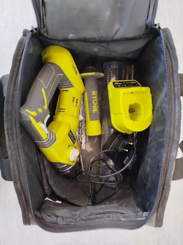 Sac de transport pour perforateur sans fil Ryobi R18SDS avec accessoires dedans.